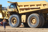 Mining Photo Stock Library - mine worker in full PPE walks to parked up haul truck. ( Weight: 1  New Image: NO)