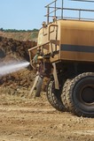 Mining Photo Stock Library - close up of water cart sprying watewr on haul road for dust suppression. ( Weight: 1  New Image: NO)