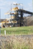 Mining Photo Stock Library - great generic shot of coal wash plant  at open cut mine.  grass plants in foreground in focus with green grass in middle ground. ( Weight: 1  New Image: NO)