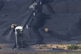 Mining Photo Stock Library - close up aerial photo of tractors stockpiling coal at shipping terminal.  conveyor working above to spread coal. ( Weight: 1  New Image: NO)