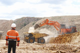 Mining Photo Stock Library - male worker in full PPE observing haul truck being loaded with overburden by excavator in open cut mine. ( Weight: 1  New Image: NO)
