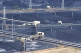 Mining Photo Stock Library - close up aerial photo of stockpiled coal awaiting ship loading at terminal.  lots of overhead and land conveyors. ( Weight: 1  New Image: NO)