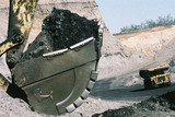 Mining Photo Stock Library - close up shot of coal in an excavator bucket with haul truck on road in background.  open cut coal mining. ( Weight: 1  New Image: NO)