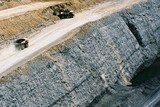 Mining Photo Stock Library - great aerial phot of haul trucks on access road above coal seam high walls.
excavator working in the background loading haul trucks. ( Weight: 1  New Image: NO)