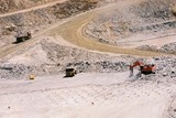 Mining Photo Stock Library - excavator and truck rotation working in gold mine.  blast drill holes in foreground.  aerial image. ( Weight: 1  New Image: NO)