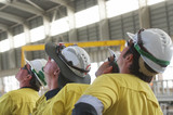 Mining Photo Stock Library - mine construction workers in full PPE observing construction work inside building plant. ( Weight: 1  New Image: NO)