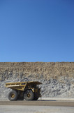 Mining Photo Stock Library - generic vertical shot of a coal haul truck in open cut mine. blue sky and high walls behind.
truck carrying overburden. ( Weight: 1  New Image: NO)