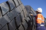 Mining Photo Stock Library - mine worker in full PPE inspecting truck tyre stockpile. ( Weight: 1  New Image: NO)
