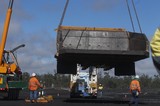 Mining Photo Stock Library - haul truck tray being lifted by a crane onto the semi trailer of a low loader.  mine workers in full PPE observing. ( Weight: 1  New Image: NO)