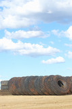 Mining Photo Stock Library - vertical shot of a truck tyre stockpile of haul trucks at a mine site.  blue sky in the background. ( Weight: 1  New Image: NO)