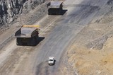 Mining Photo Stock Library - light vehicle passing two 2 haul trucks on access road in open cut coal mine.  aerial photo. ( Weight: 1  New Image: NO)