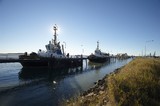 Mining Photo Stock Library - tugboats berthed at wharf in early morning light.  blue sky behind. ( Weight: 1  New Image: NO)