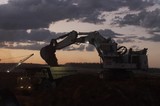 Mining Photo Stock Library - great dusk shot of excavator loading a haul truck.  generic dusk photo.  machines with lights on. ( Weight: 1  New Image: NO)
