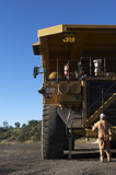 Mining Photo Stock Library - mine site worker in full PPE  performing maintenance on haul truck at workshop in coal mine. ( Weight: 1  New Image: NO)