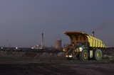 Mining Photo Stock Library - dusk photo of haul truck unloading overburden in open cut coal mine.  power station in background. ( Weight: 1  New Image: NO)