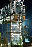 Mining Photo Stock Library - infrastructure workers in full PPE including harness working off scaffolding at a bridge gantry site.  photo taken at night. ( Weight: 1  New Image: NO)