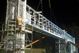 Mining Photo Stock Library - workers in full PPE installing a gantry bridge over a motorway during the evening.  Scaffolding installed on both sides of the bridge. ( Weight: 1  New Image: NO)