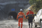 Mining Photo Stock Library - photo of two underground workers walking towards the portal.  light vehicle 4wd driving down the mine site entrance. ( Weight: 1  New Image: NO)