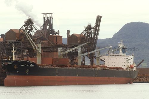 Iron ore ship in port being loaded . - Mining Photo Stock Library