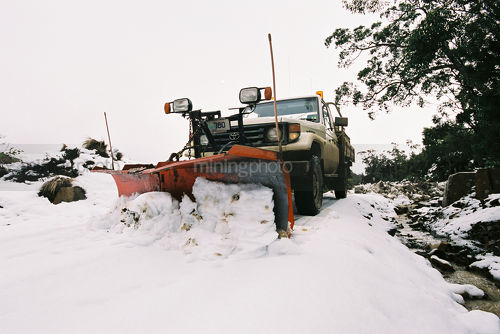 Snow plow on front of light vehicle  clearing roads - Mining Photo Stock Library