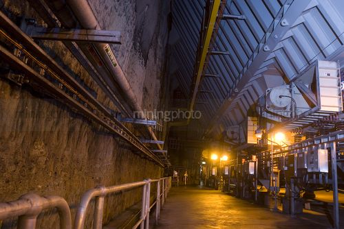 Underground coal loading from rail carriage into hopper and onto conveyor to power station. - Mining Photo Stock Library
