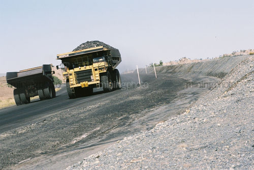 Trucks passing on haul road - Mining Photo Stock Library