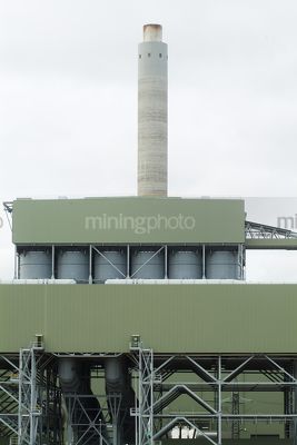 Power station smokestack with plant in foreground - Mining Photo Stock Library