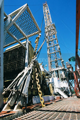 Drill rig derrick with blue sky behind - Mining Photo Stock Library