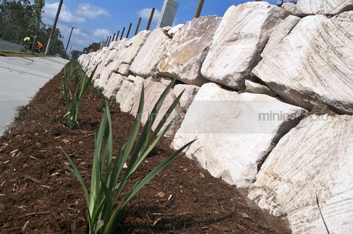 Rock retaining wall in new subdivision - Mining Photo Stock Library
