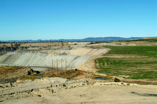 Revegetation of open cut coal mine with coal haul road in the middle.  lots of green planting shot wide. - Mining Photo Stock Library
