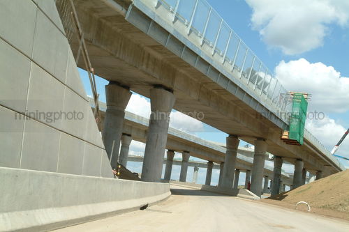 Construction of freeway overpass - Mining Photo Stock Library
