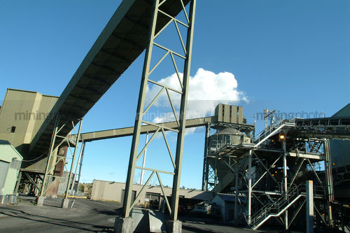 Coal wash plant with steel structures and conveyor in foreground. - Mining Photo Stock Library