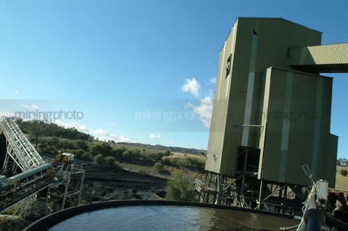 Coal conveyor and wash plant with water holding tank in foreground. - Mining Photo Stock Library
