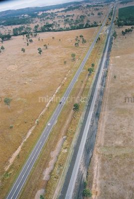 2 lane highway in rural bush with heavy rail track alongside. aerial shot - Mining Photo Stock Library