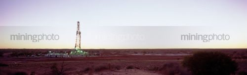 Panorama of oil and gas rig in the desert.  lots of space either side for text. - Mining Photo Stock Library