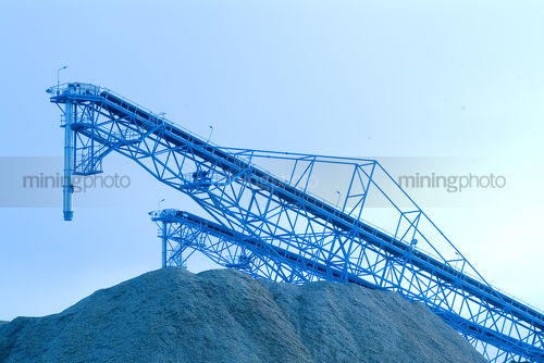 Conveyors stockpiling sawdust/woodchips. clean blue image - Mining Photo Stock Library