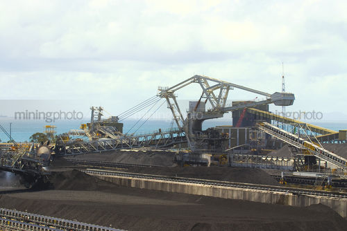 Close up of coal reclaimer working at shipping terminal. - Mining Photo Stock Library