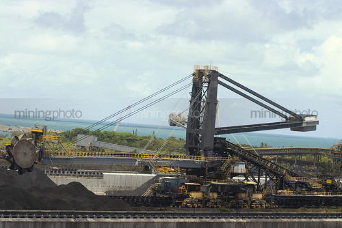 Close up of coal reclaimer working at shipping terminal. - Mining Photo Stock Library