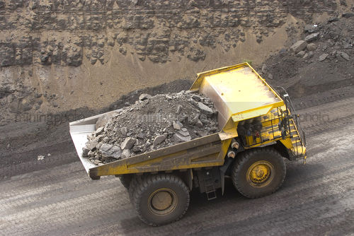 Loaded haul truck on open cut mine site carrying overburden.  aerial birds eye shot. - Mining Photo Stock Library
