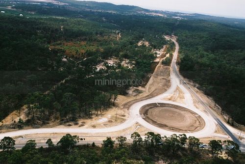Aerial shot of a roundabout being constructed on a highway - Mining Photo Stock Library
