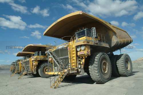 Haul trucks parked at the go line - Mining Photo Stock Library