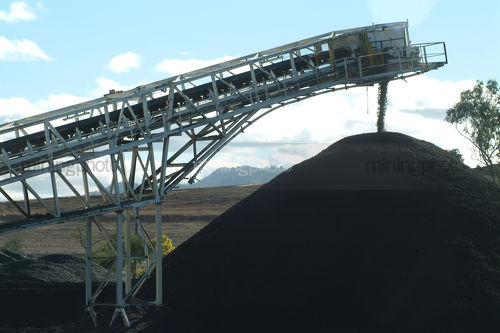 Close up of coal conveyor delivering coal to stockpile on mine site. - Mining Photo Stock Library