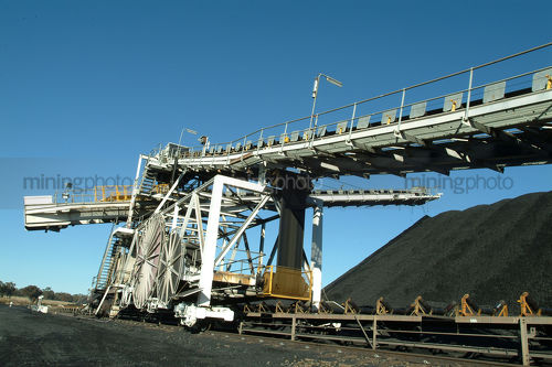 Coal spreader delivering coal to stockpile at terminal. - Mining Photo Stock Library