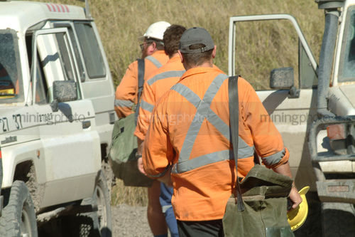 Workers walking to light vehicle pre shift. - Mining Photo Stock Library