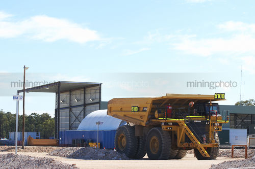 Haul truck parked at maintenance shed on a mine site. - Mining Photo Stock Library