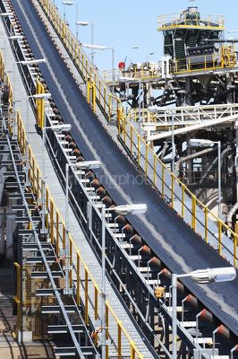 Coal conveyor close up with wash plant in background.  vertical image. - Mining Photo Stock Library