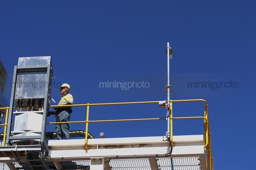 Mine engineer working on an electrical box up on coal plant.  generic image  - Mining Photo Stock Library