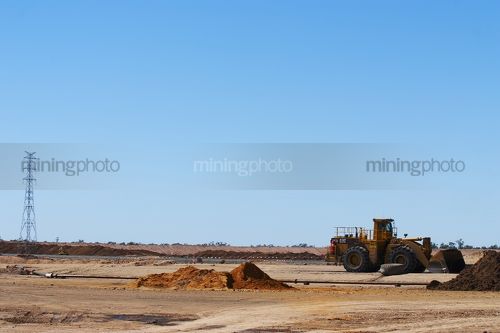 Loader clearing on remote mine site - Mining Photo Stock Library
