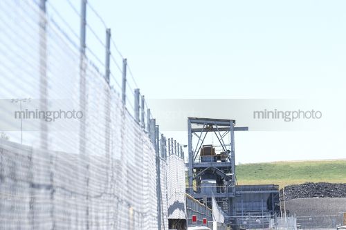 Coal conveyor with barb wire fence - Mining Photo Stock Library