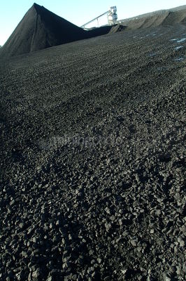 Closeup of chunks of coal with stockpile and conveyor in background - Mining Photo Stock Library